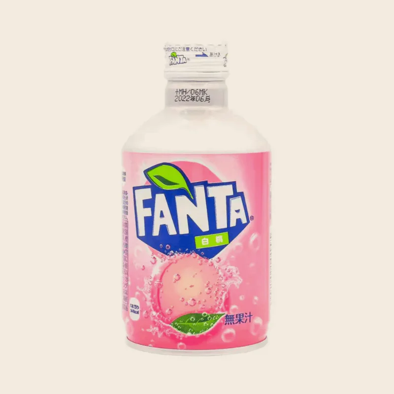 A Japanese import can of Fanta peach on a dark table