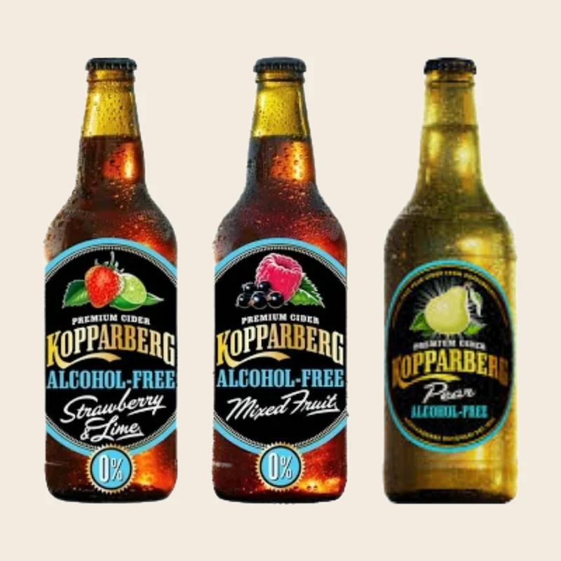 Three alcohol-free Kopparberg bottles — strawberry and lime, mixed fruit, and pear